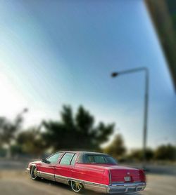 Close-up of car on road against sky