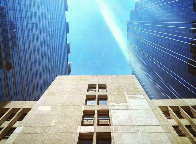 architecture, built structure, building exterior, low angle view, modern, skyscraper, office building, city, tall - high, tower, glass - material, reflection, building, sky, day, window, blue, outdoors, tall, no people