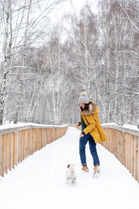 Woman with dog on snow
