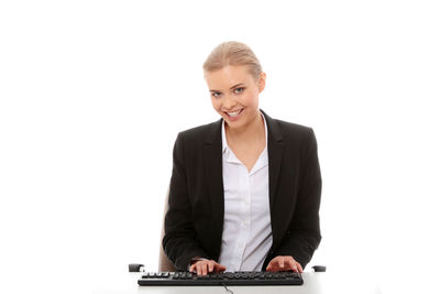 Portrait of a smiling young woman over white background