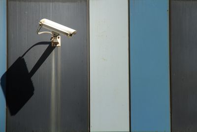 Close-up of metal gate against wall