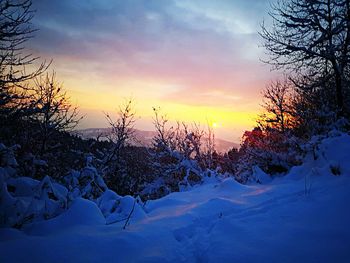 Snow covered landscape against sky