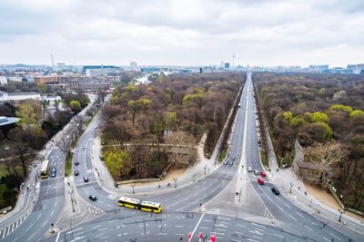 Aerial view of vehicles on road against sky