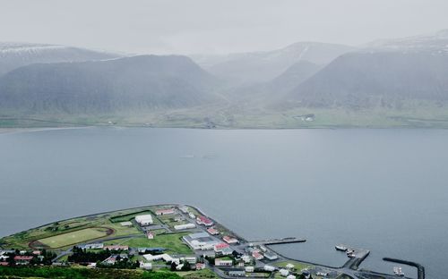 Scenic view of lake and mountains against sky