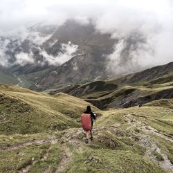 Rear view of man walking on mountain