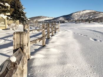 Snow covered landscape against clear sky