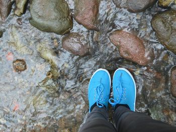 Low section of person standing on rock