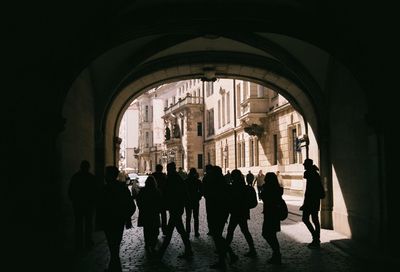 Group of silhouette people in corridor of building