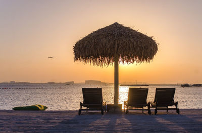 Scenic view of beach against sky during sunset