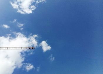 Low angle view of airplane flying against blue sky