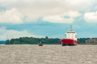 Ship sailing on sea against sky