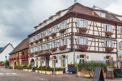 Street with historical half-timbered houses in eguisheim, alsace, france