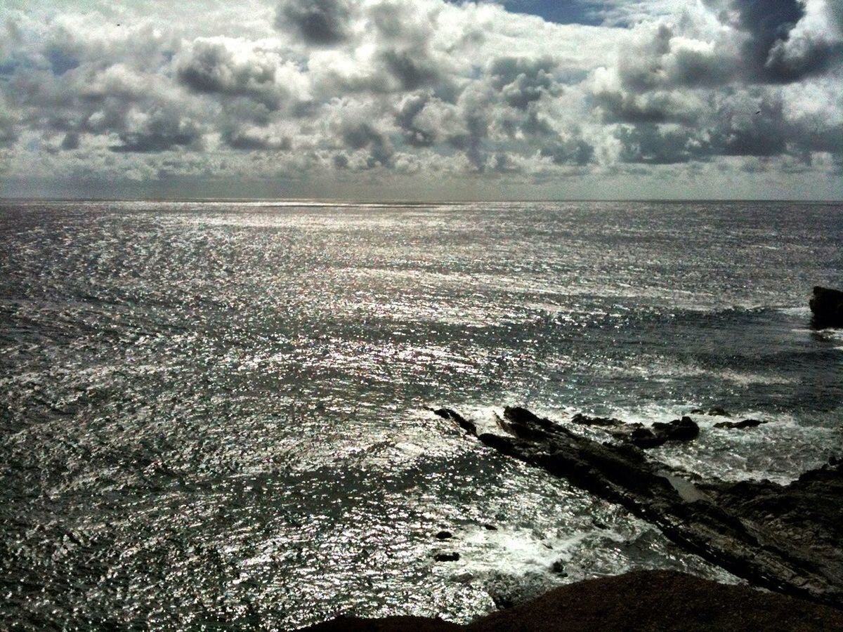 sea, sky, water, horizon over water, cloud - sky, tranquil scene, tranquility, scenics, beauty in nature, cloudy, nature, beach, cloud, shore, idyllic, coastline, remote, rock - object, day, non-urban scene