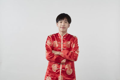 Portrait of a smiling young woman against white background