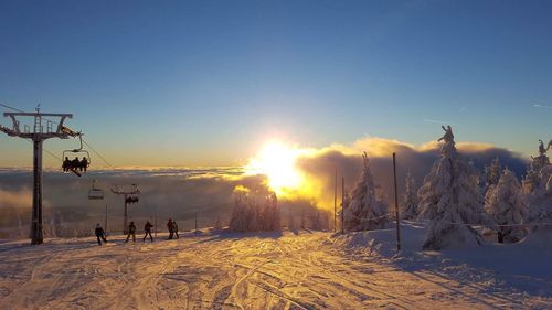 Scenic view of ski field against sky during sunset