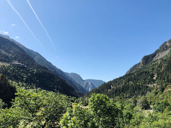 Scenic view of mountains against blue sky