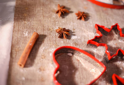 Background with cookie cutters, cookies, anise and cinnamon sticks. selective focus