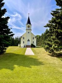Church by building against sky