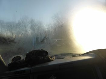 Car on road against cloudy sky