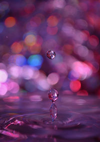 Close-up of drop falling on water