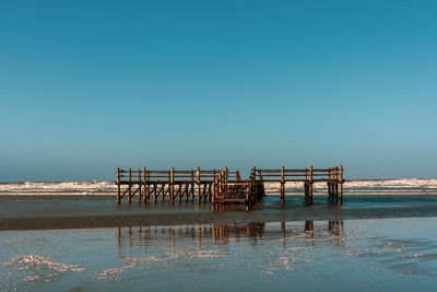 Pile dwelling on the norsee beach of sankt peter-ording in germany