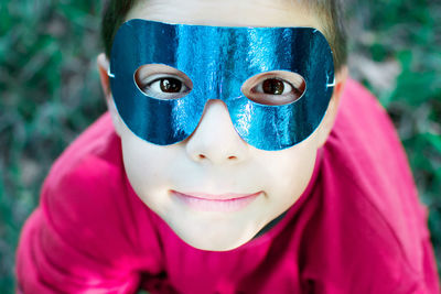 Portrait of boy wearing blue mask