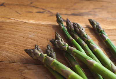 Close-up of fresh green asparagus on wooden background