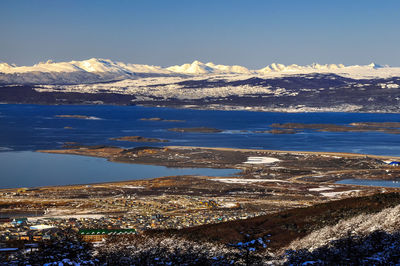 Scenic view of snowcapped mountains against blue sky