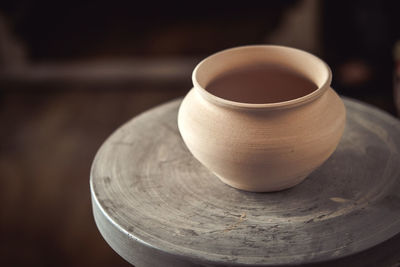 Clay pot on a potter's wheel close-up. copy spase