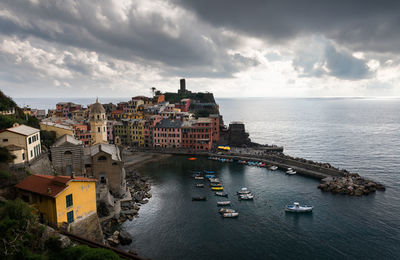 High angle view of buildings by sea against sky