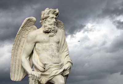 Low angle view of statue against cloudy sky