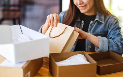 Midsection of woman holding box