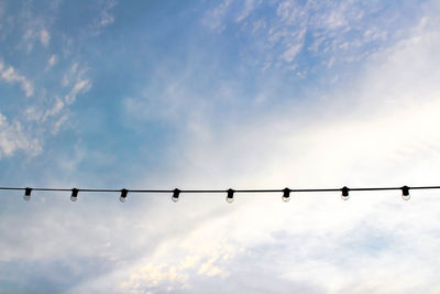 Low angle view of lighting equipment against sky