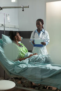 Female doctor examining patient in clinic