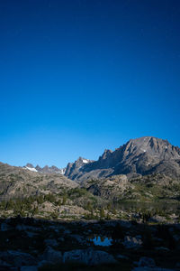 Scenic view of mountains against clear blue sky