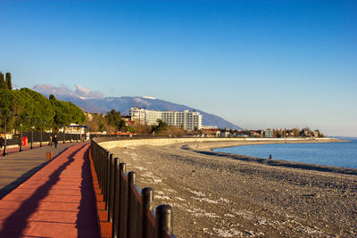 Calm sea against clear blue sky