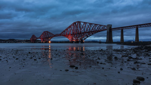 View of bridge over river against cloudy sky