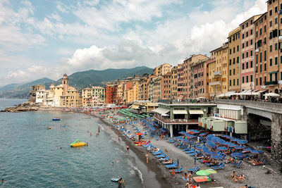 Buildings by sea against sky in city