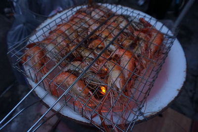 High angle view of meat on barbecue grill