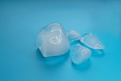 Close-up of ice cream over water against blue background