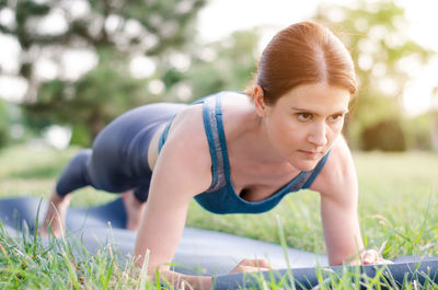 Young woman exercising in park