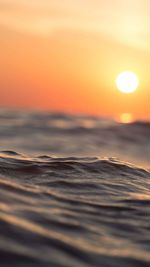 Water level of sea against sky during sunset