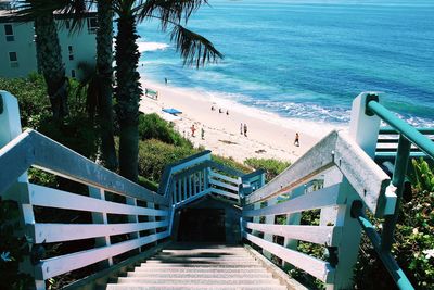 Staircase at beach against sky