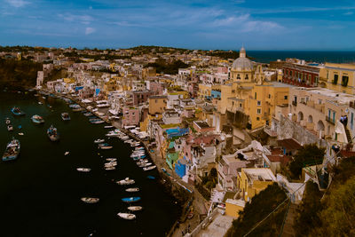 High angle view of townscape by sea against sky