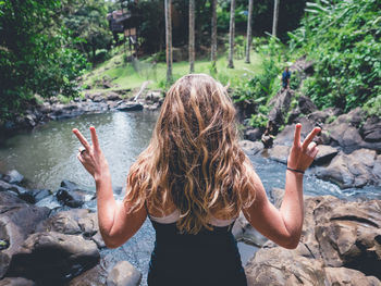 Rear view of girl standing by water