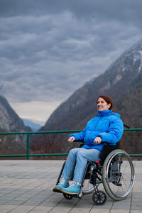 Rear view of man sitting on road