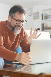 Young man using laptop at table