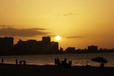 People on beach at sunset