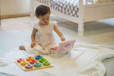 High angle view of boy sitting on table