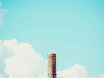 Low angle view of smoke stack against sky